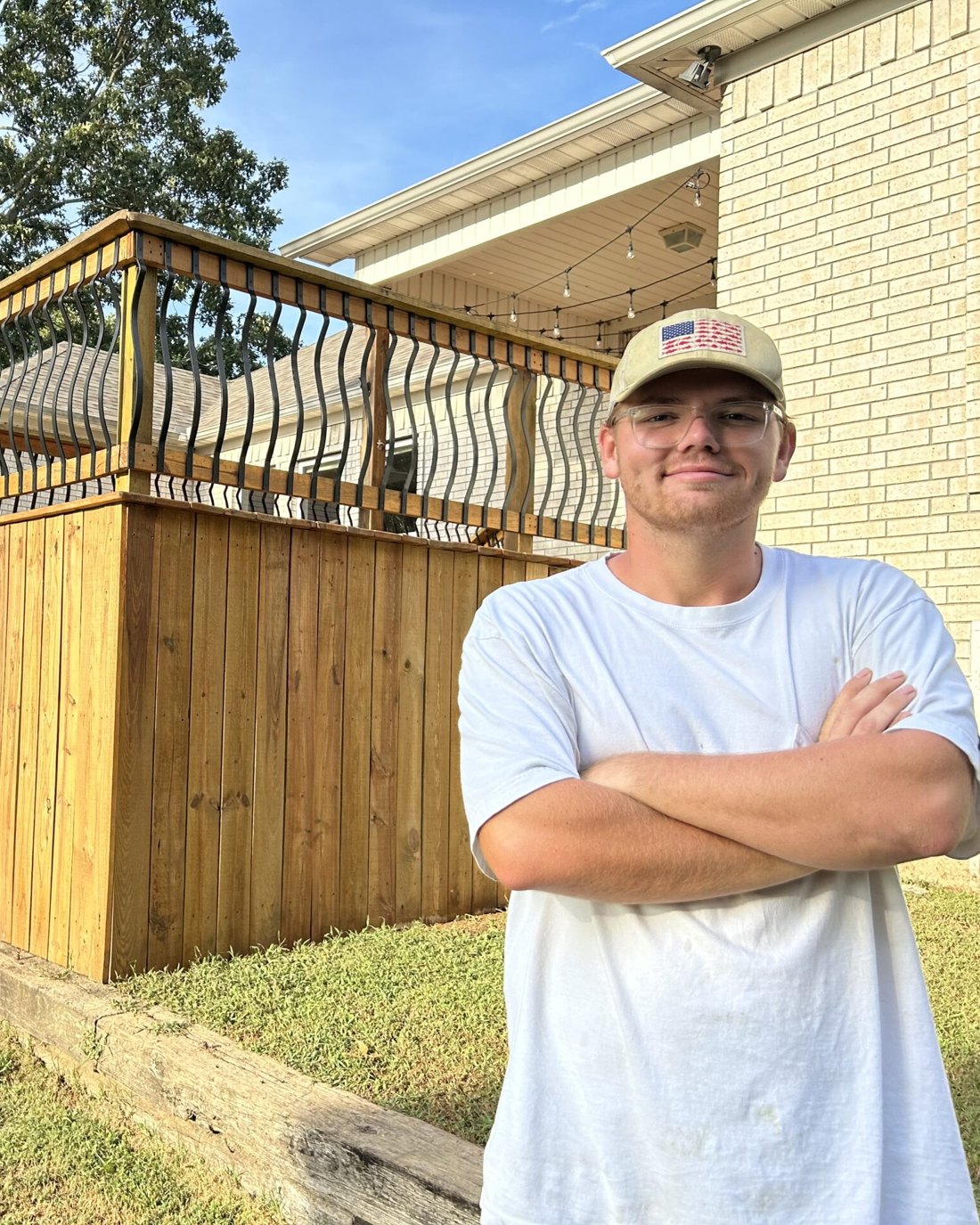 The owner of Wood Seal Experts in front of a finished project
