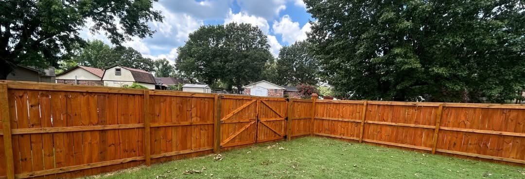 Same fence after cleaning and cedar-tone stain