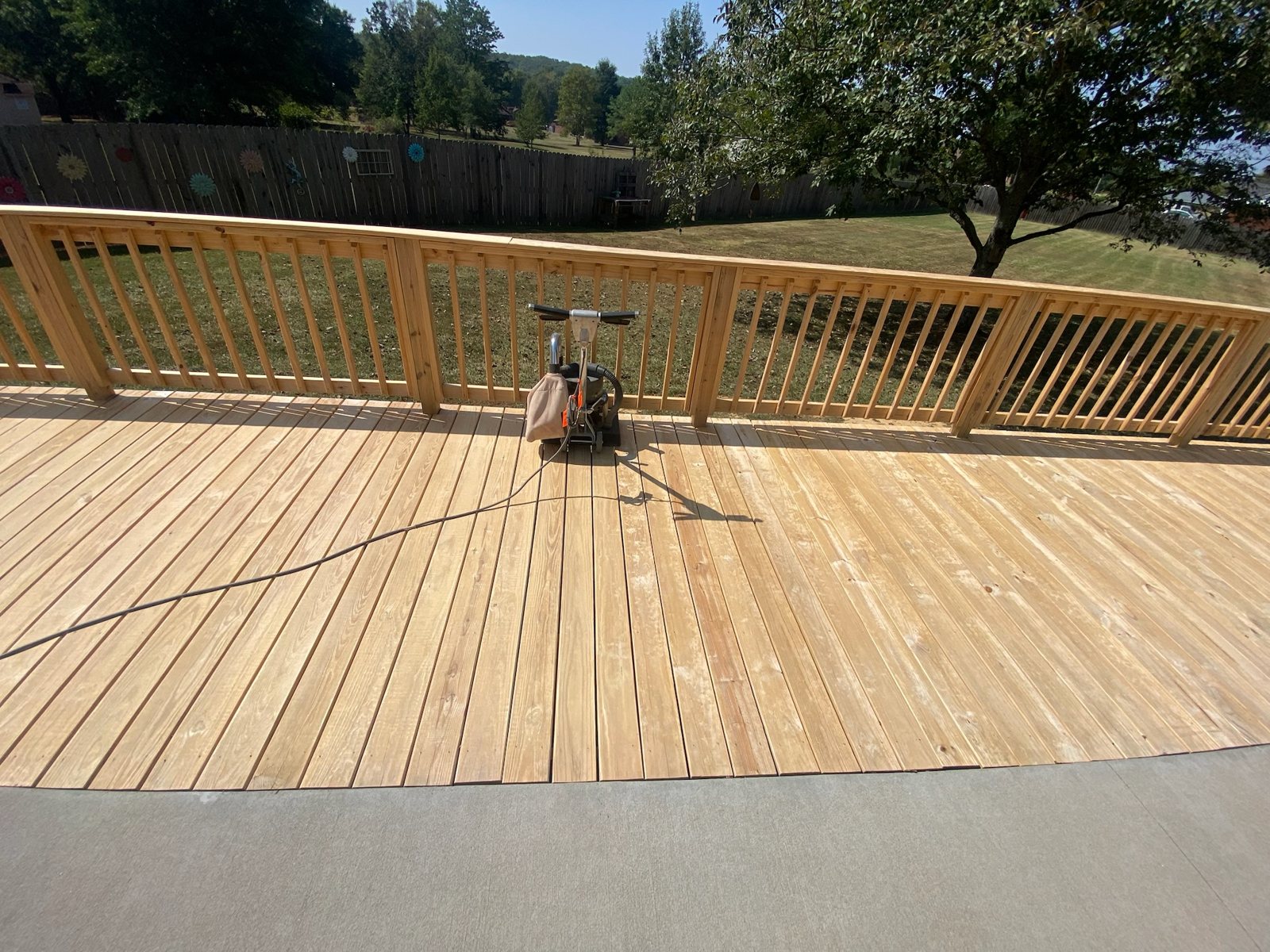 Large multi-level backyard deck with a rich stained finish