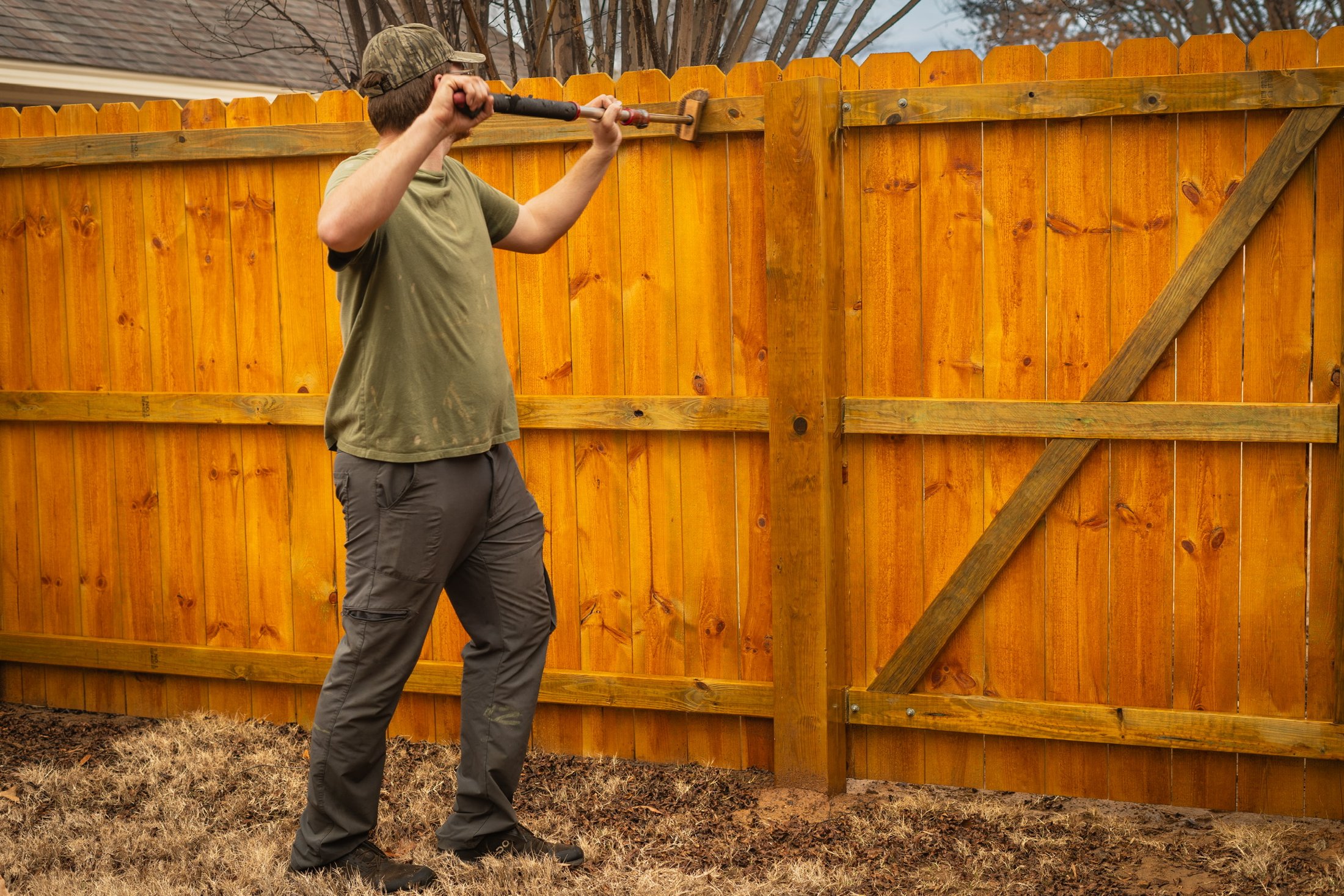 Wood Seal Experts staining a fence in Central Arkansas